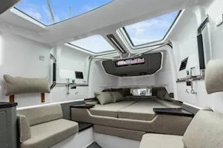 Slide: The Image of Interior of 2023 Axopar 37 boat with luxurious seating and marina view. - 17
