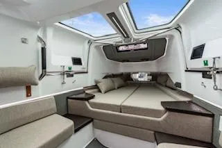 Slide: The Image of 2023 Axopar 37 boat interior with modern dashboard and blue seating in marina. - 20
