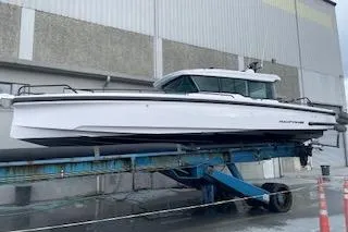 Slide: The Image of 2023 Axopar 37 boat docked in marina, showcasing sleek design and modern features. - 4