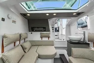 Slide: The Image of Luxurious interior of 2023 Axopar 37 boat with blue seating and marina view. - 18
