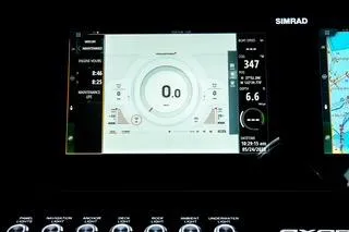 Slide: The Image of 2023 Axopar 37 boat dashboard with navigation screens and steering wheel. - 24