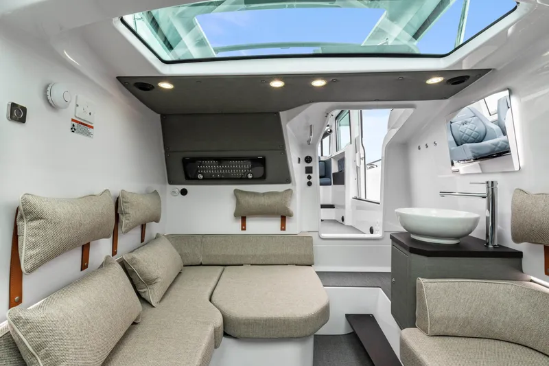 Slide: The Image of Luxurious interior of 2023 Axopar 37 boat with modern seating and skylight. - 30