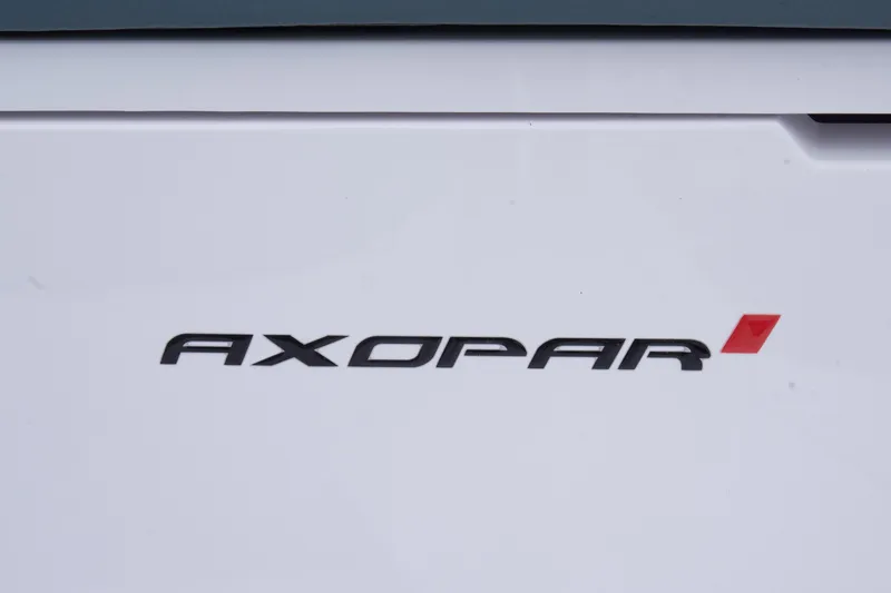Slide: The Image of Axopar 37 logo on a 2023 model boat, featuring sleek black and red design. - 33