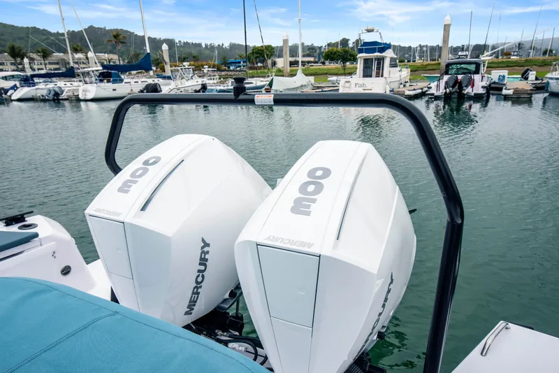 Slide: The Image of 2023 Axopar 37 with twin Mercury 300 engines docked at a marina. - 38