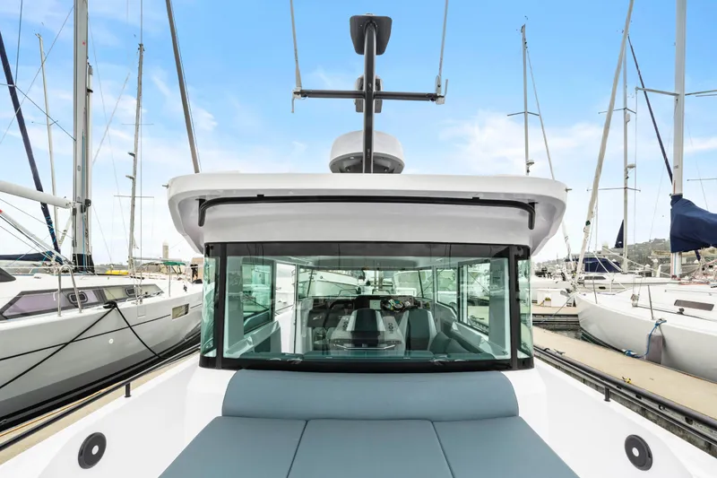 Slide: The Image of 2023 Axopar 37 boat docked at marina, showcasing sleek design and modern features. - 39