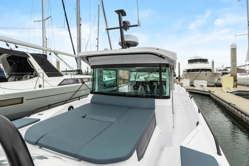 Slide: The Image of 2023 Axopar 37 boat docked at marina, featuring sleek design and spacious deck. - 41