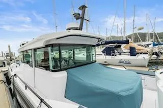 Slide: The Image of 2023 Axopar 37 boat docked at marina, featuring sleek design and spacious deck. - 6