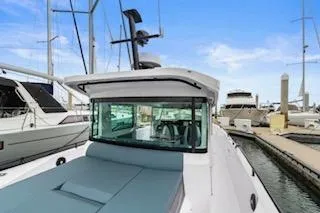 Slide: The Image of 2023 Axopar 37 boat docked in marina, featuring sleek design and modern amenities. - 9