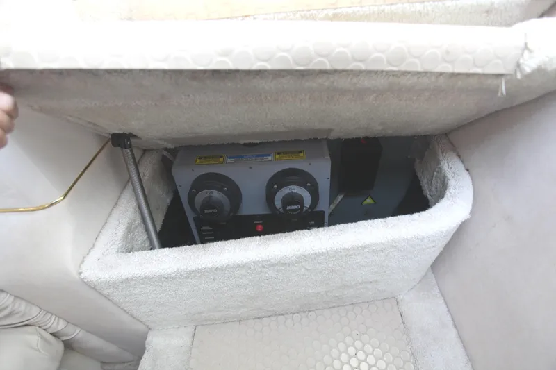 Slide: The Image of 1997 Sea Ray 330 Express Cruiser interior storage compartment with equipment. - 10