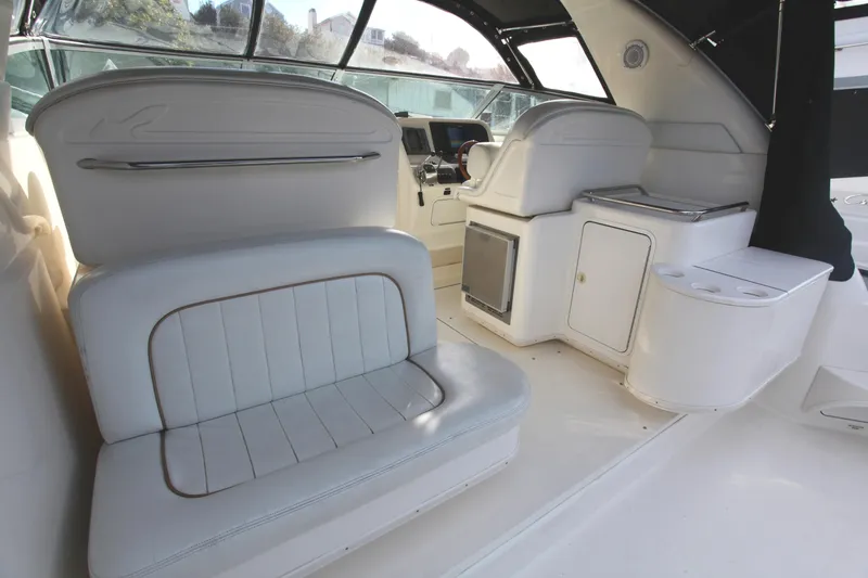 Slide: The Image of Interior of 1997 Sea Ray 330 Express Cruiser with white seating and helm station. - 11