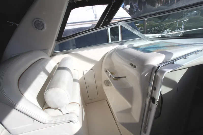 Slide: The Image of 1997 Sea Ray 330 Express Cruiser interior with white seating and dashboard. - 12
