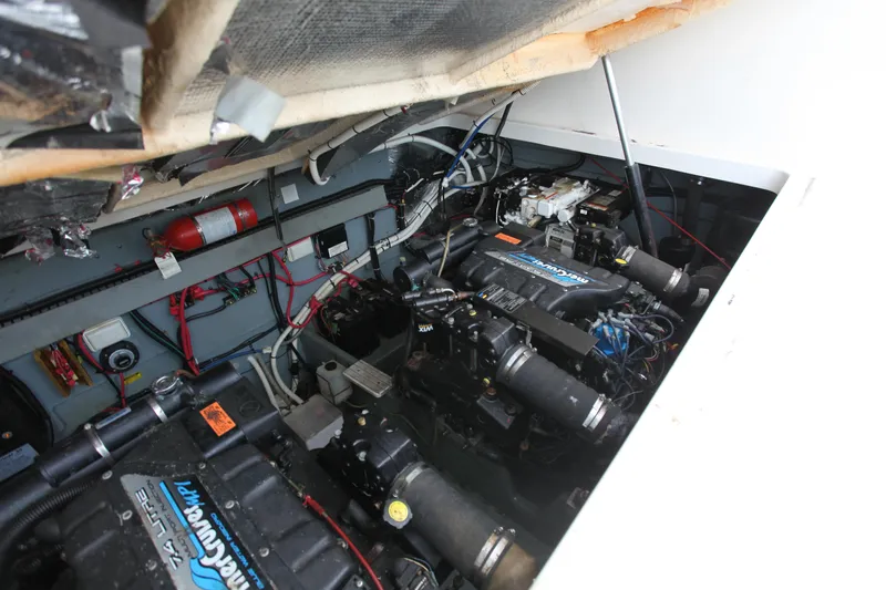 Slide: The Image of Engine compartment of a 1997 Sea Ray 330 Express Cruiser, showcasing dual engines and wiring. - 18