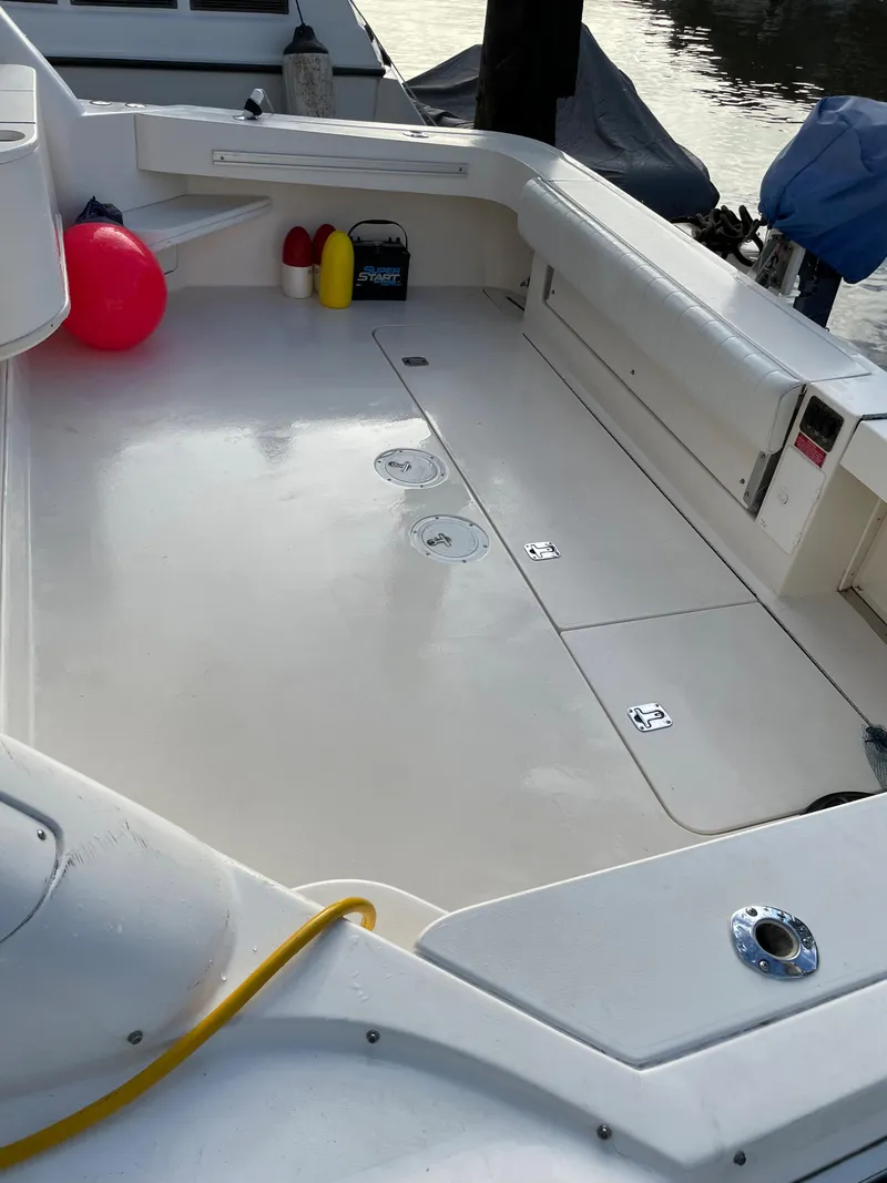 Slide: The Image of 1997 Sea Ray 330 Express Cruiser deck with storage compartments and safety equipment. - 28