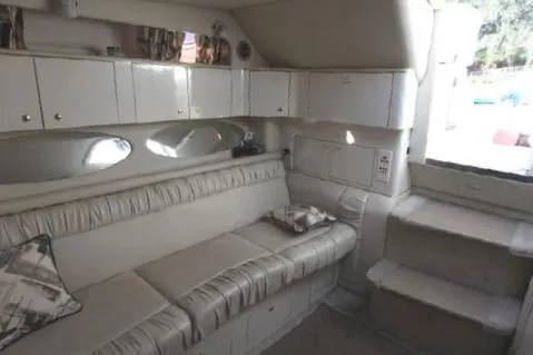 Slide: The Image of Interior of 1997 Sea Ray 330 Express Cruiser with white seating and cabinetry. - 32