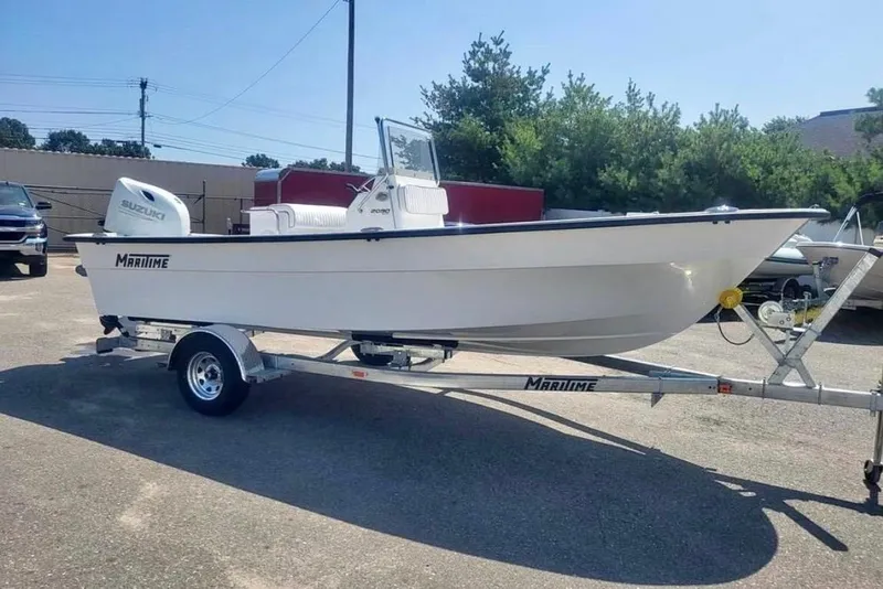 The Image of 2024 Maritime 2090 Skiff boat on trailer, featuring Suzuki outboard motor. - 1