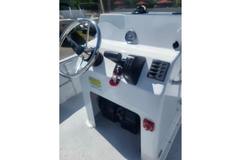Slide: The Image of 2024 Maritime 2090 Skiff console with steering wheel and controls, featuring a sleek design. - 8