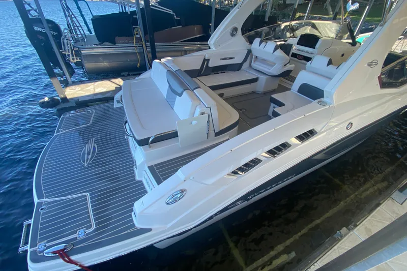 Slide: The Image of 2018 Chaparral 337 SSX boat docked, featuring spacious seating and sleek design. - 10