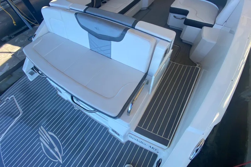 Slide: The Image of 2018 Chaparral 337 SSX boat interior with white seating and striped flooring. - 11