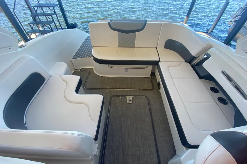 Slide: The Image of 2018 Chaparral 337 SSX boat interior with white seating and water view. - 12
