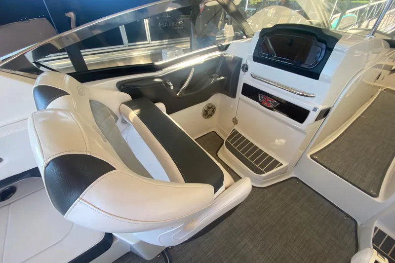 Slide: The Image of 2018 Chaparral 337 SSX boat interior with sleek seating and modern dashboard. - 15