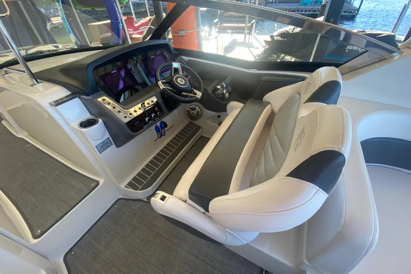 Slide: The Image of 2018 Chaparral 337 SSX boat cockpit with modern steering and dual seating. - 16