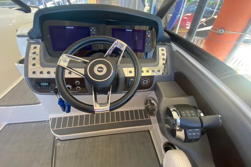 Slide: The Image of 2018 Chaparral 337 SSX helm with dual Simrad displays and modern steering wheel. - 18