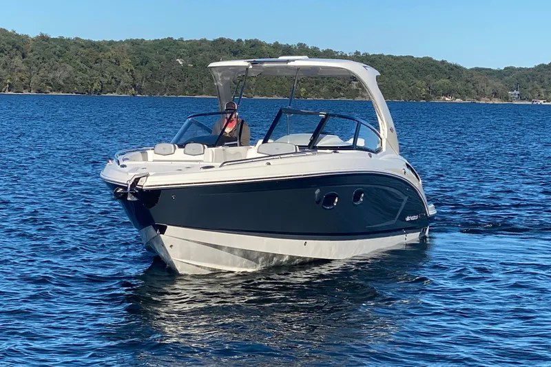Slide: The Image of 2018 Chaparral 337 SSX boat on a calm lake with forested shoreline. - 2