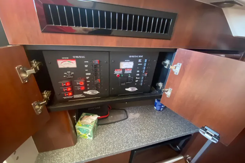Slide: The Image of Electrical panel inside 2018 Chaparral 337 SSX boat, featuring control switches and meters. - 21