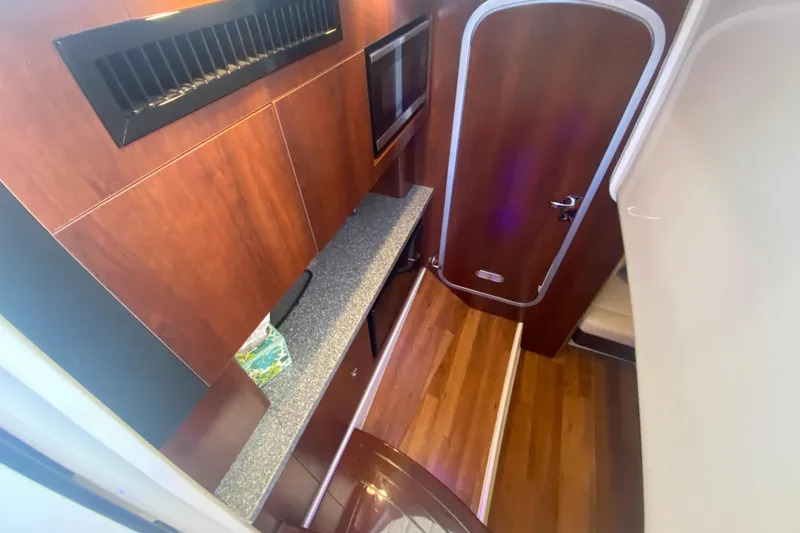 Slide: The Image of 2018 Chaparral 337 SSX interior with wood finish and modern amenities. - 22