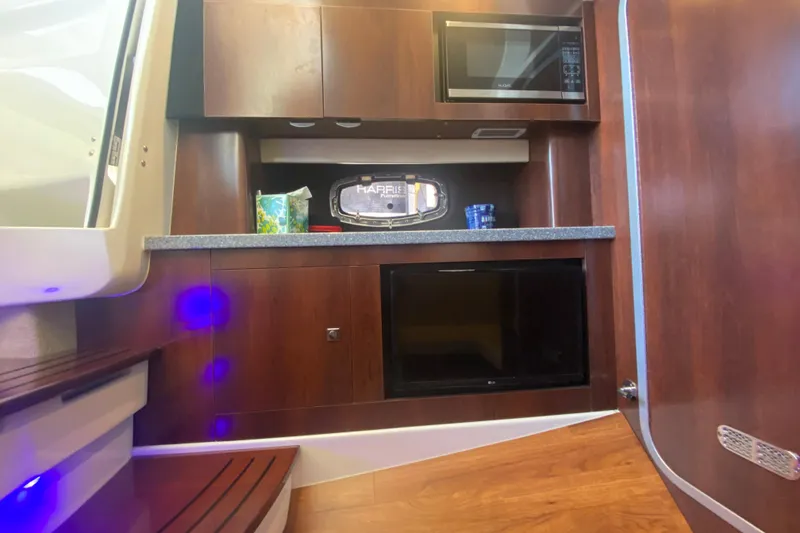 Slide: The Image of 2018 Chaparral 337 SSX interior with microwave, wooden cabinetry, and modern design. - 26