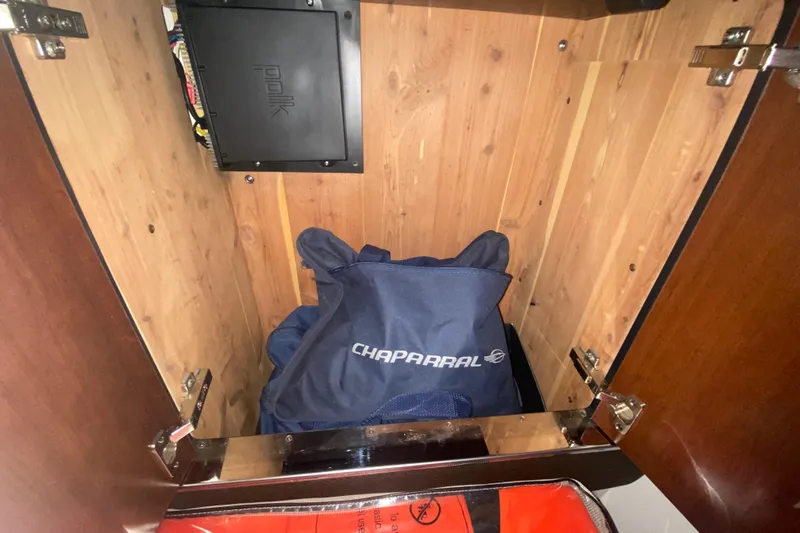 Slide: The Image of Open cabinet with Chaparral bag and Polk audio equipment inside. - 27