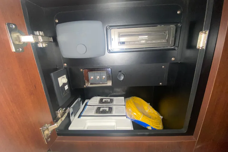 Slide: The Image of 2018 Chaparral 337 SSX interior cabinet with electronic controls and storage items. - 28