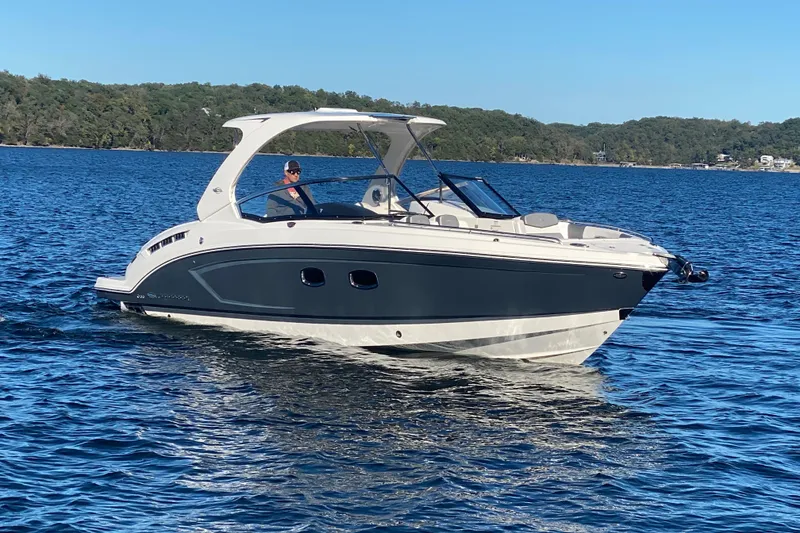 Slide: The Image of 2018 Chaparral 337 SSX boat cruising on a serene lake. - 3