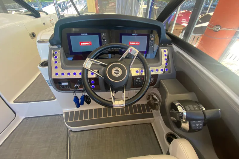 Slide: The Image of 2018 Chaparral 337 SSX boat dashboard with dual Simrad displays and modern controls. - 30