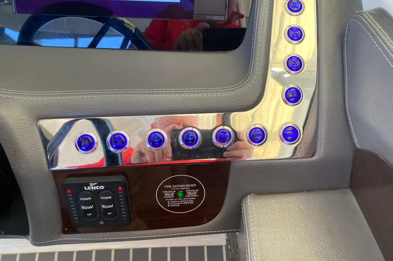 Slide: The Image of Control panel of 2018 Chaparral 337 SSX boat with illuminated buttons and Lenco controls. - 32