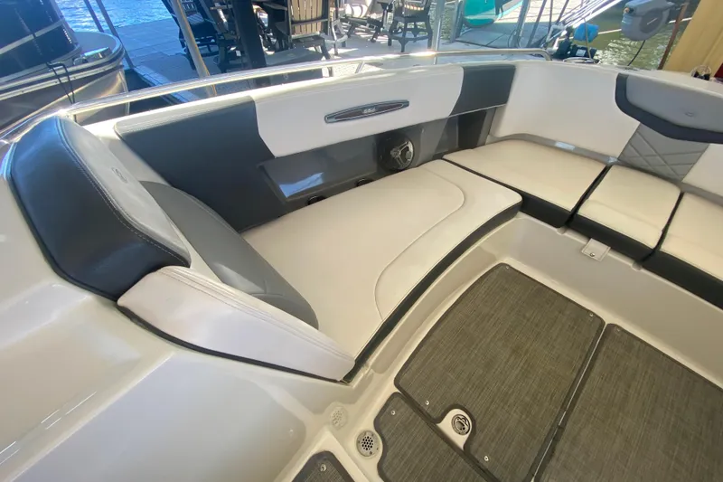 Slide: The Image of 2018 Chaparral 337 SSX boat interior with cushioned seating and sleek design. - 37