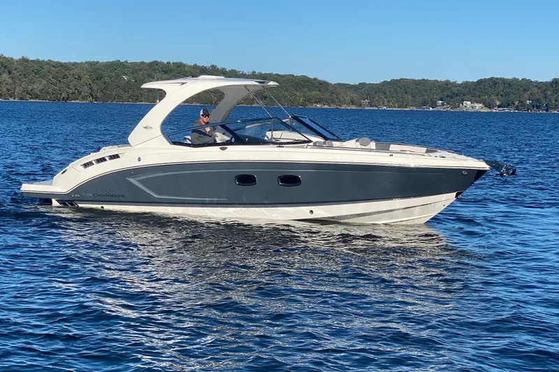 Slide: The Image of 2018 Chaparral 337 SSX boat cruising on a lake under clear blue skies. - 4