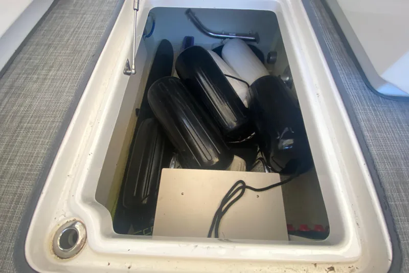 Slide: The Image of Storage compartment of 2018 Chaparral 337 SSX boat with fenders and equipment. - 40