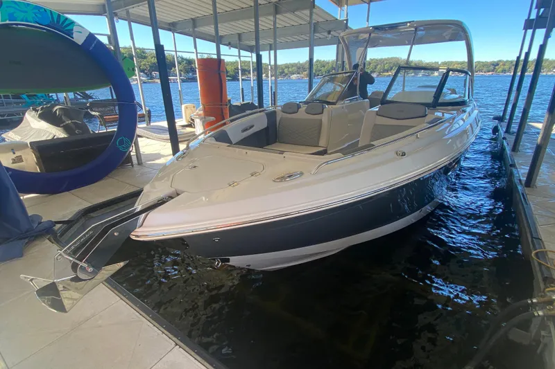 Slide: The Image of 2018 Chaparral 337 SSX boat docked in a marina with scenic lake view. - 50