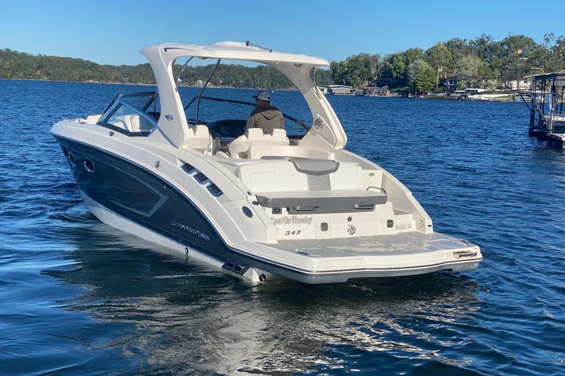 Slide: The Image of 2018 Chaparral 337 SSX boat cruising on a serene lake. - 53