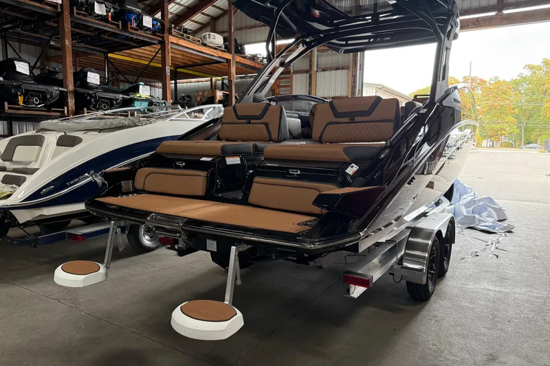 Slide: The Image of 2026 Yamaha Boats 275SD in a warehouse, showcasing sleek design and luxurious seating. - 13