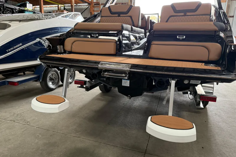 Slide: The Image of 2026 Yamaha Boats 275SD with extended swim platform and luxurious seating in a showroom. - 14