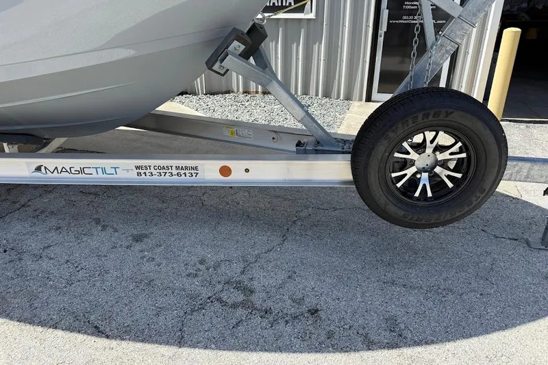 Slide: The Image of Trailer for 2026 Sea Pro 262 Offshore boat with Magic Tilt branding. - 2