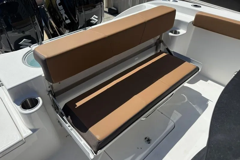 Slide: The Image of 2026 Sea Pro 262 Offshore boat with brown cushioned seating and Suzuki engines. - 22
