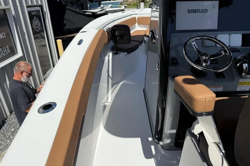 Slide: The Image of 2026 Sea Pro 262 Offshore boat interior with steering wheel and seating. - 24