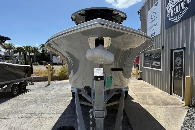 Slide: The Image of 2026 Sea Pro 262 Offshore boat on trailer outside marine shop. - 3