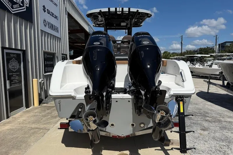 Slide: The Image of 2026 Sea Pro 262 Offshore boat with dual outboard engines at a marina. - 9