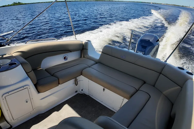Slide: The Image of 2020 NauticStar 243 DC boat interior with comfortable seating on open water. - 10