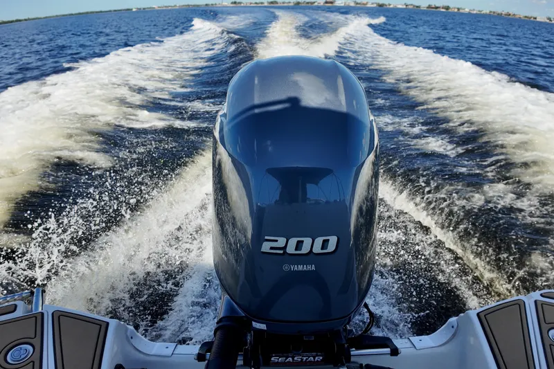Slide: The Image of Yamaha 200 engine powering a 2020 NauticStar 243 DC boat on open water. - 13