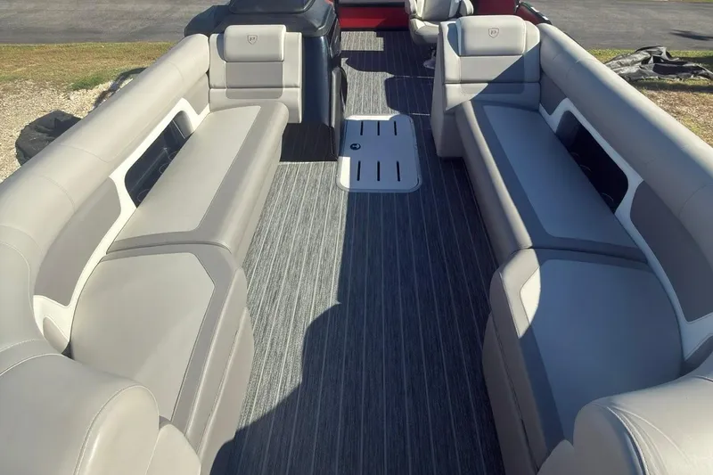 Slide: The Image of 2024 Premier 250 Solaris boat interior with gray seating and flooring. - 2